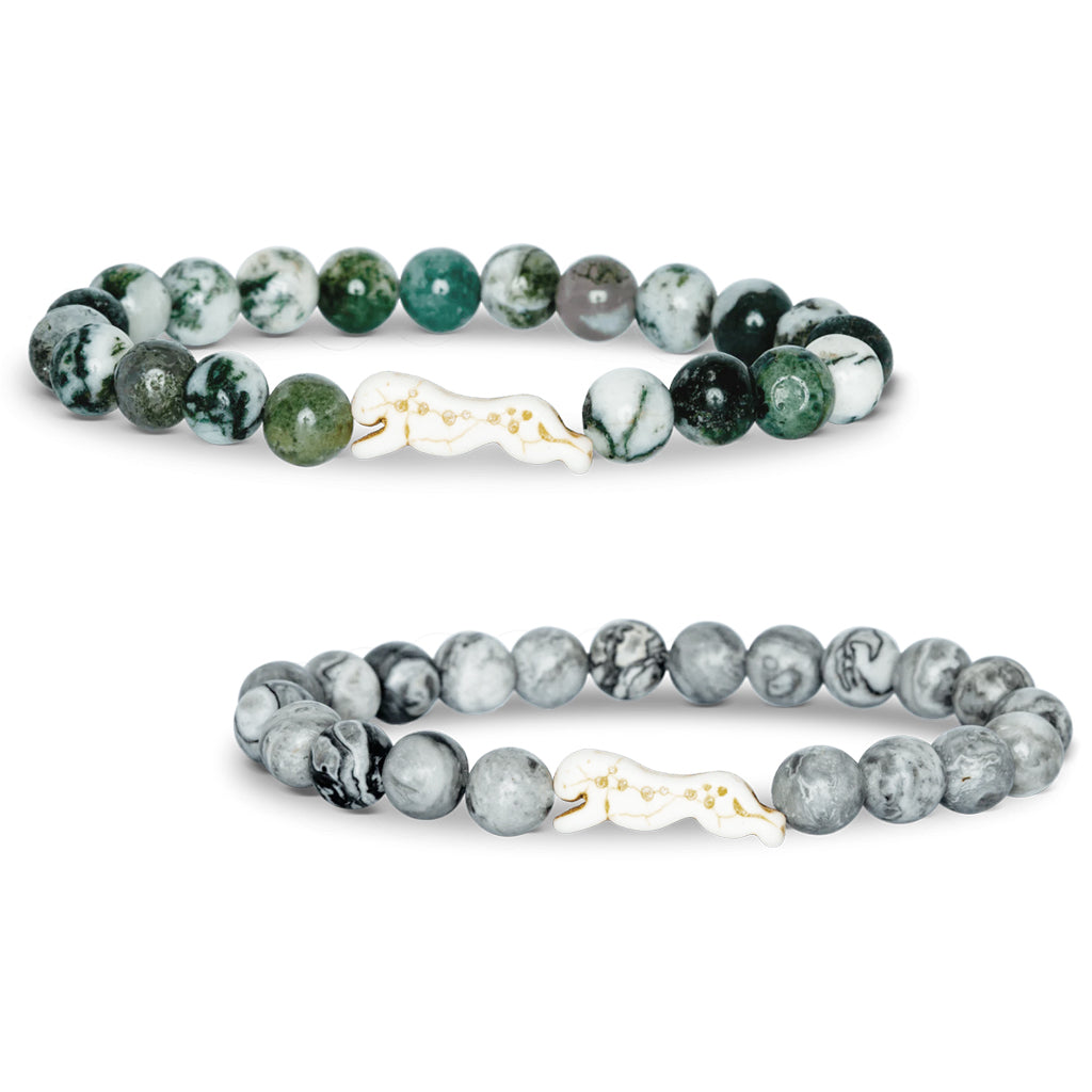 Two beaded bracelets with cream-colored cheetah charms in Acacia Stone and Cloudburst Stone.