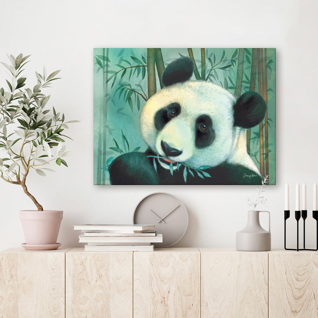 Canvas print of a giant panda bear in a bamboo forest on a wall above a wooden shelf.