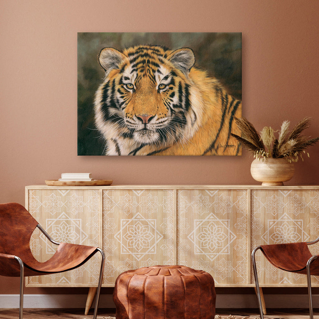 Tiger canvas print painting on a wall above a decorative cabinet with a brown chair and ottoman.