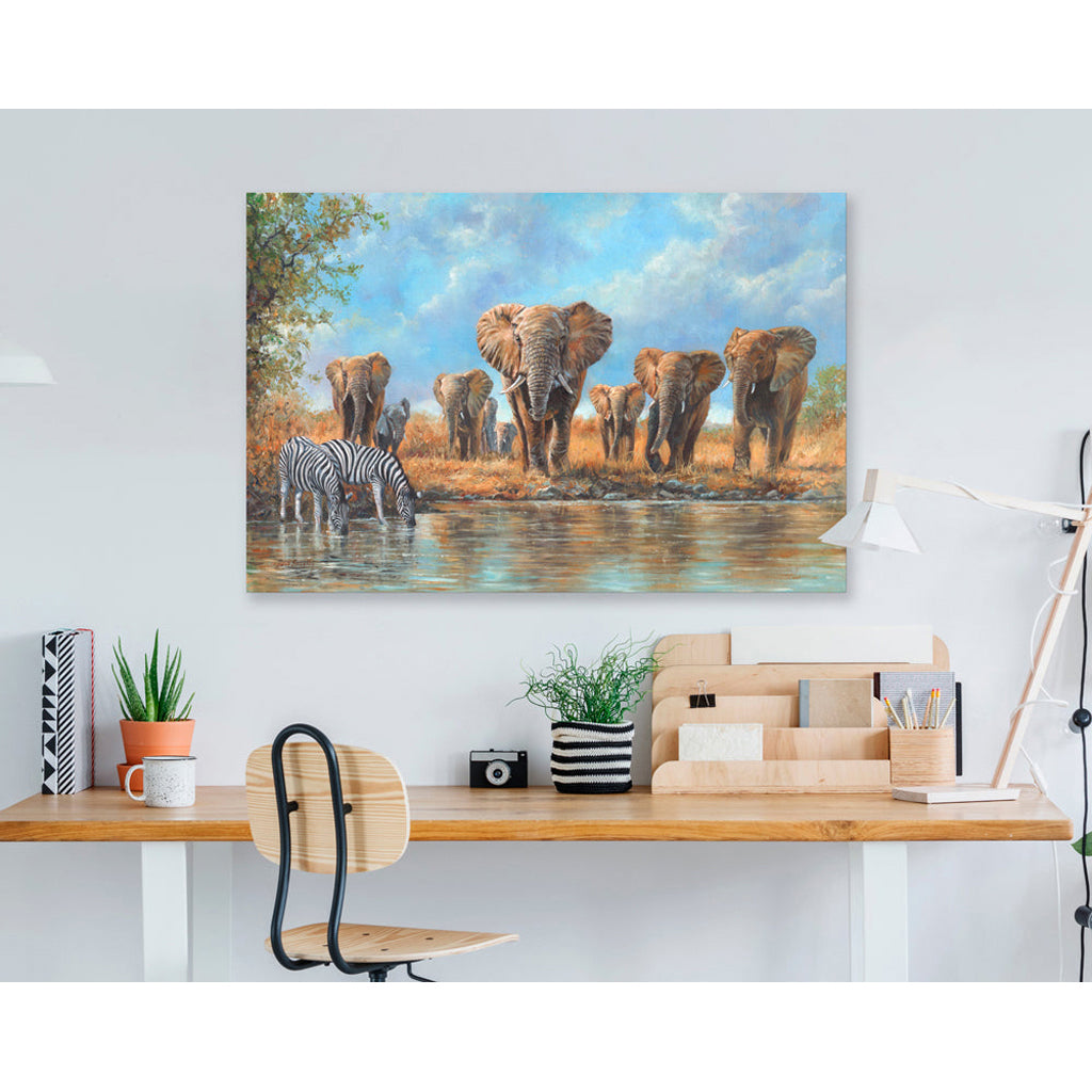 Canvas print of elephants and a zebra at a watering hole in an office setting.
