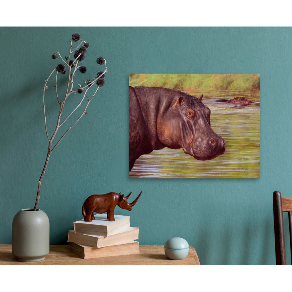 Hippo Canvas Print painting on a teal wall with decorative items on a table.