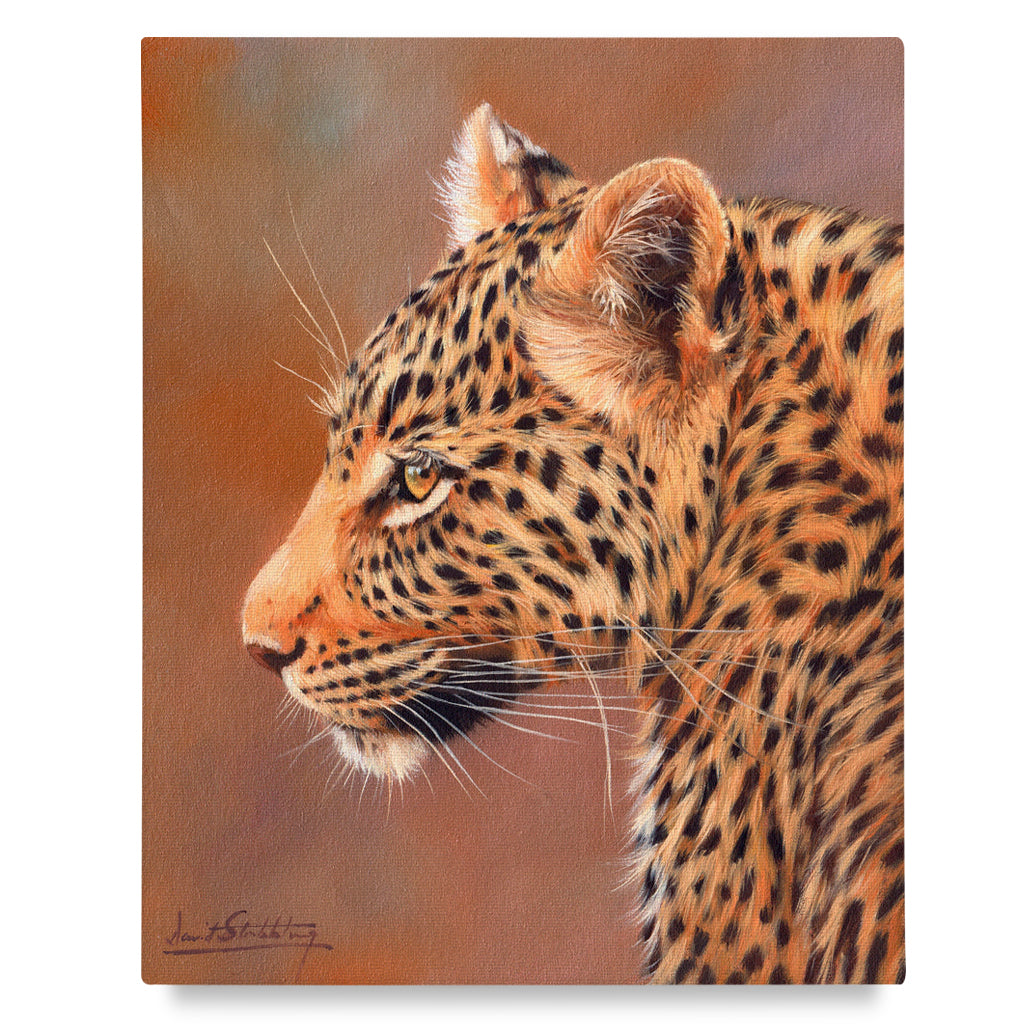 Canvas print of a leopard&#39;s profile with a warm color palette.