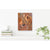 Canvas Print artwork of a leopard on a shelf with books and a plant.
