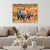 Canvas print of two rhinos in a natural setting above a beige sofa with decorative items.