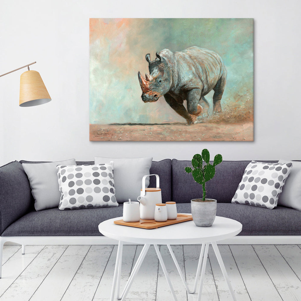Living room with a gray sofa, coffee table, and Canvas Print wall art of a charging rhinoceros.