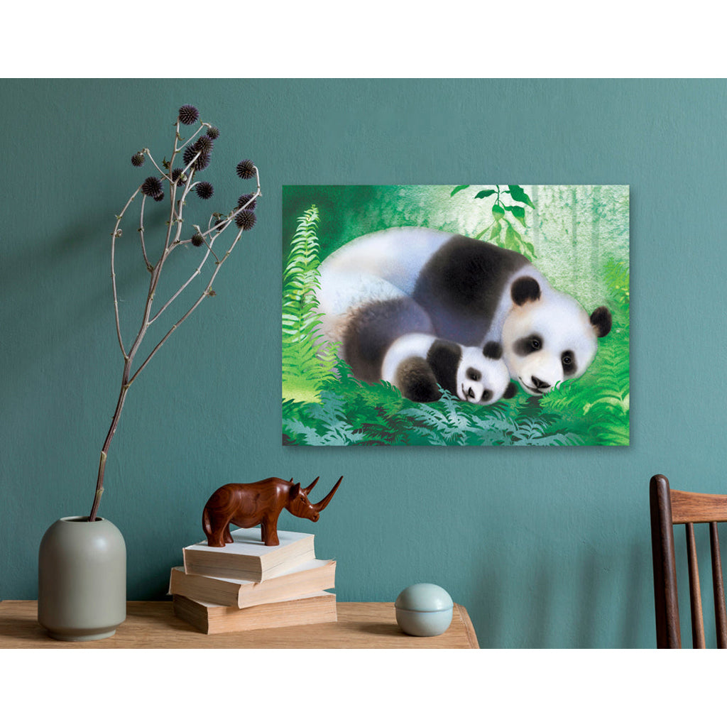 Canvas print of mom and baby giant pandas on a green wall above a wooden table with decorative items.