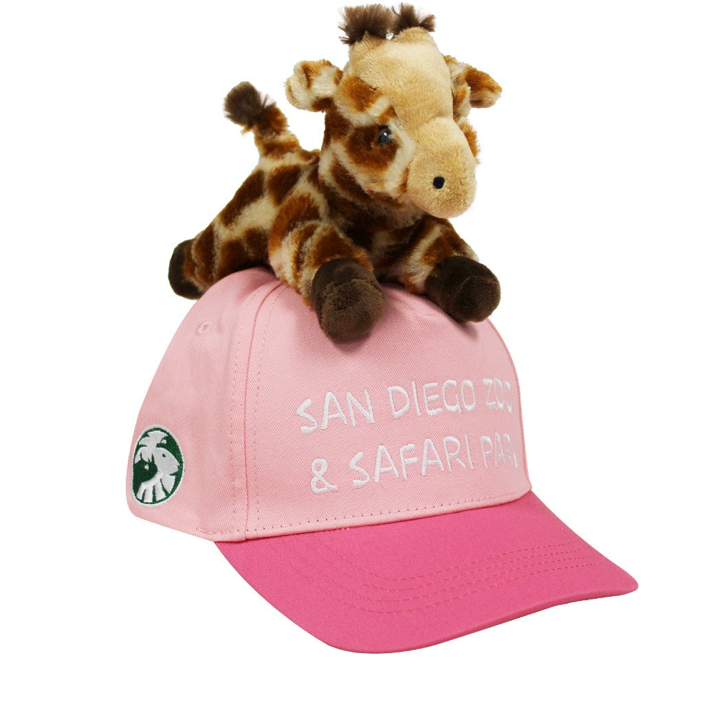 Plush giraffe toy on a pink cap with 'San Diego Zoo &amp; Safari Park' text