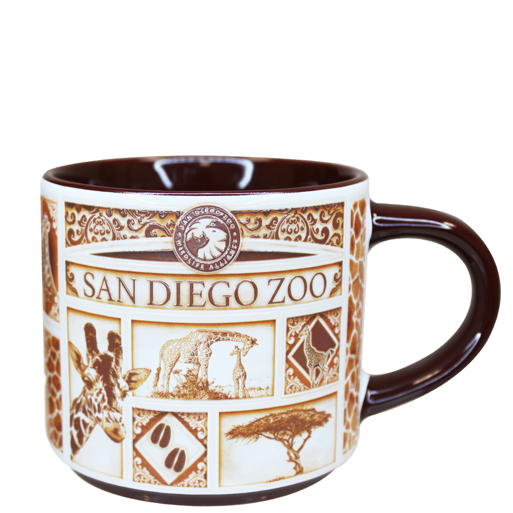 A San Diego Zoo &amp; Safari Park Delft-style ceramic mug with a white exterior decorated with brown safari-themed illustrations and text, featuring a dark brown handle and interior.