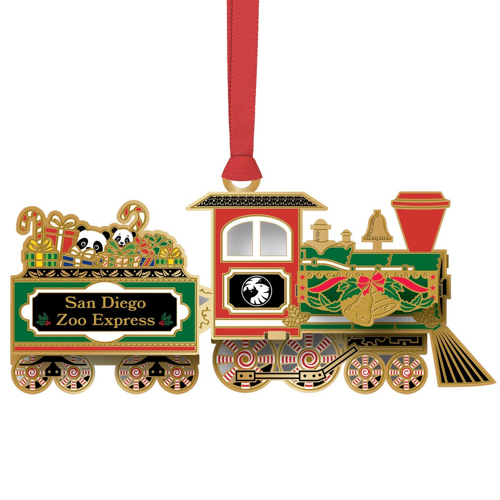 A decorative Christmas ornament shaped like a vintage train, with a red hanging ribbon. The ornament features green, red, gold, and black detailing, with the text 'San Diego Zoo Express' on the cargo car and cartoon pandas visible in the cargo area.