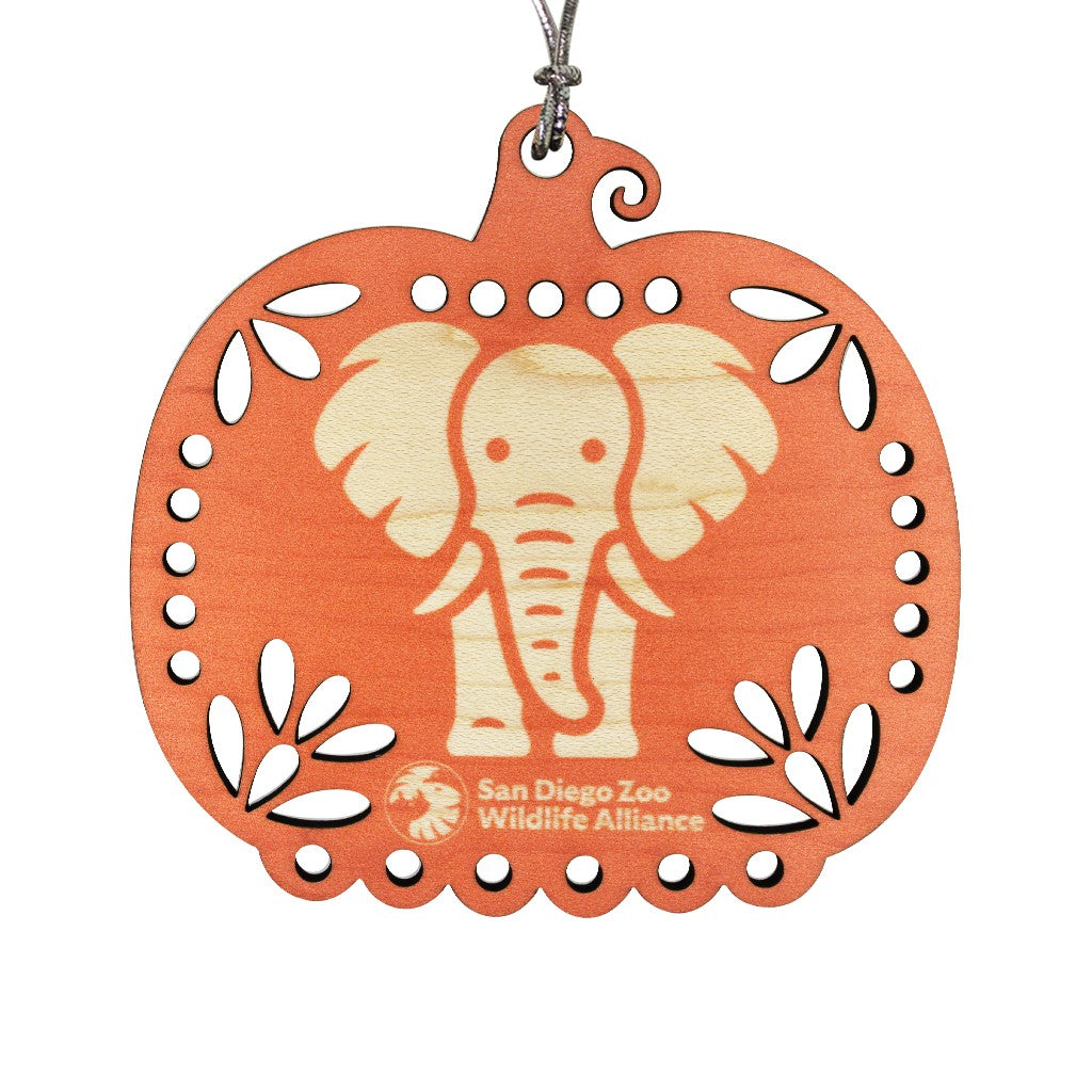 A laser-cut wooden pumpkin ornament featuring a light natural wood elephant design in the center, with the San Diego Zoo Wildlife Alliance logo at the bottom. The ornament is orange with a silver hanging string.
