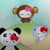 Hello Kitty wildlife plushies- a giant panda, a monkey, and a shark with bows on a light green background.