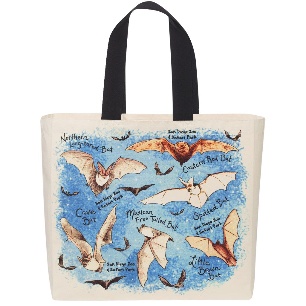 An off-white canvas tote bag with black shoulder straps, featuring a colorful printed illustration of various bat species on a blue watercolor-style background. San Diego Zoo &amp; Safari Park exclusive