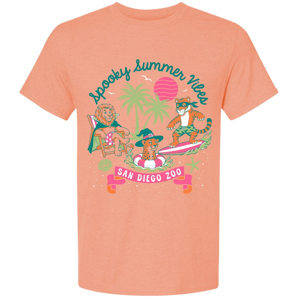 A coral orange  peach short-sleeve t-shirt with a colorful graphic print on the front. The graphic features cartoon animals at a beach-themed 'Spooky Summer Vibe' event at 'San Diego Zoo', with palm trees, a pink sun, and a pink banner.