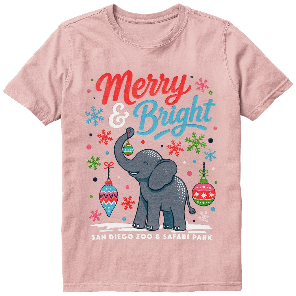 A light pink short-sleeve kids youth crewneck t-shirt featuring a festive Christmas graphic with a gray elephant, colorful ornaments, snowflakes, and the text 'Merry & Bright' and 'SAN DIEGO ZOO & SAFARI PARK'.